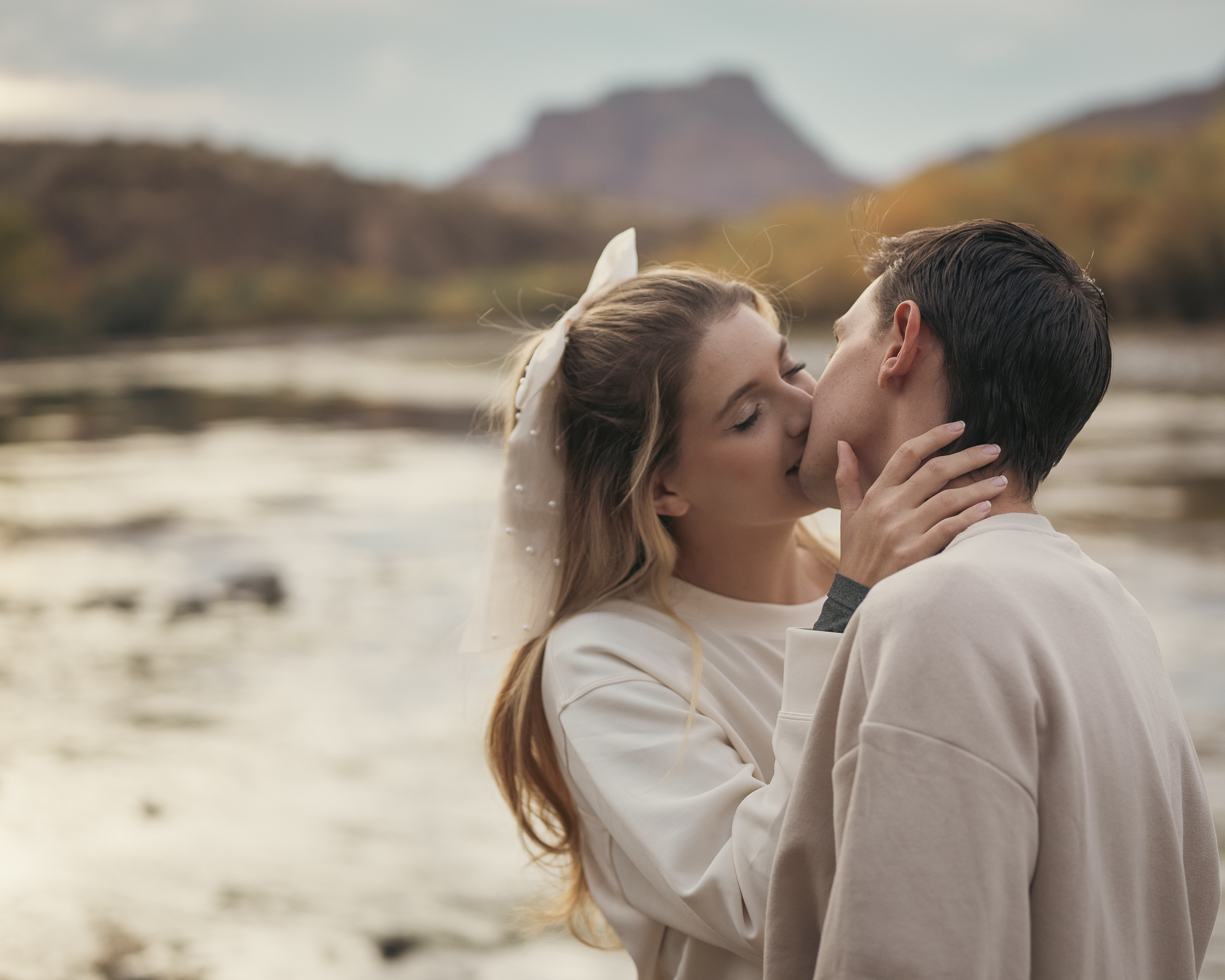 Couple sharing intimate kiss by the Lower Salt River during engagement photo session
