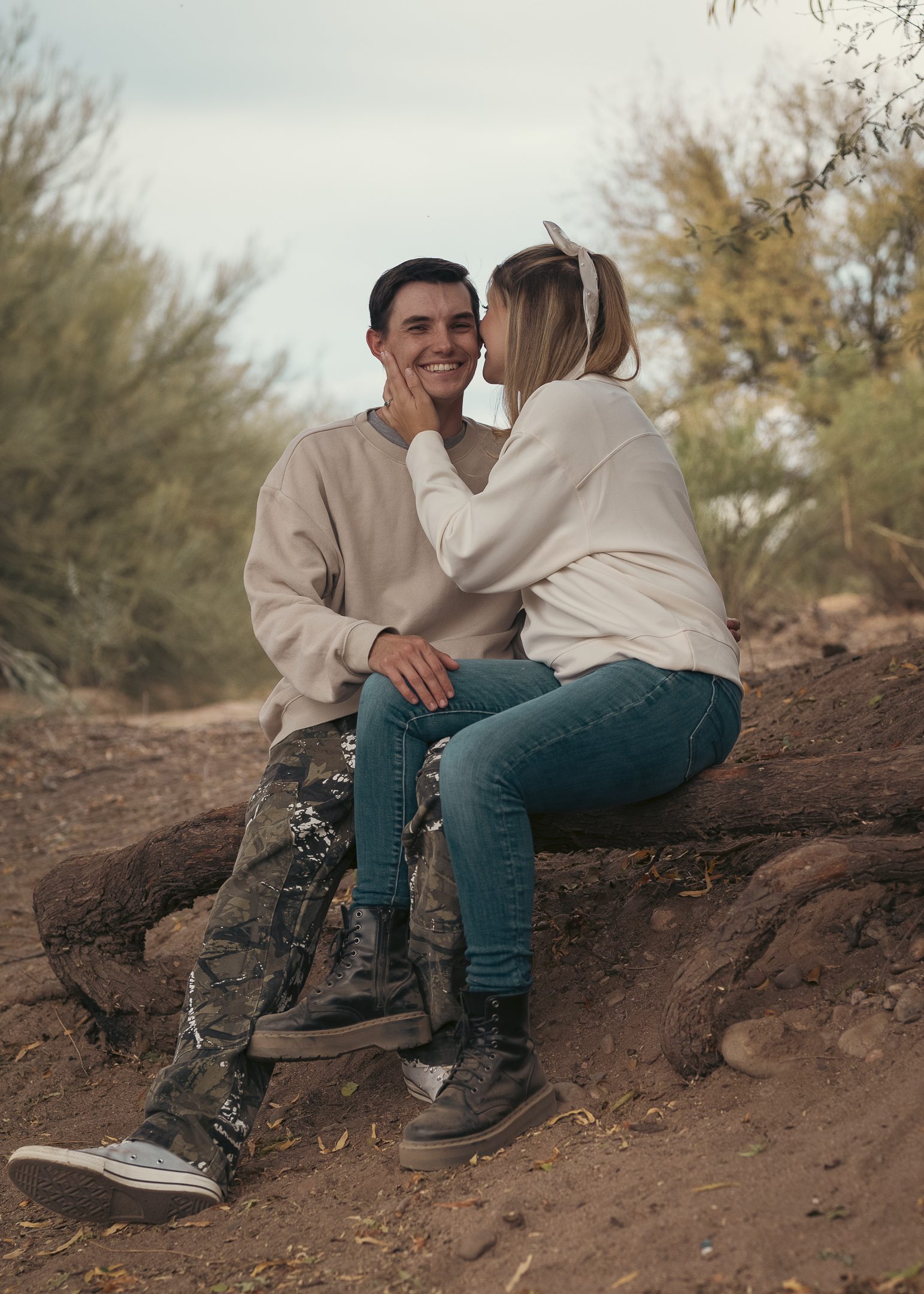 Couple sitting on tree stump along the Lower Salt River