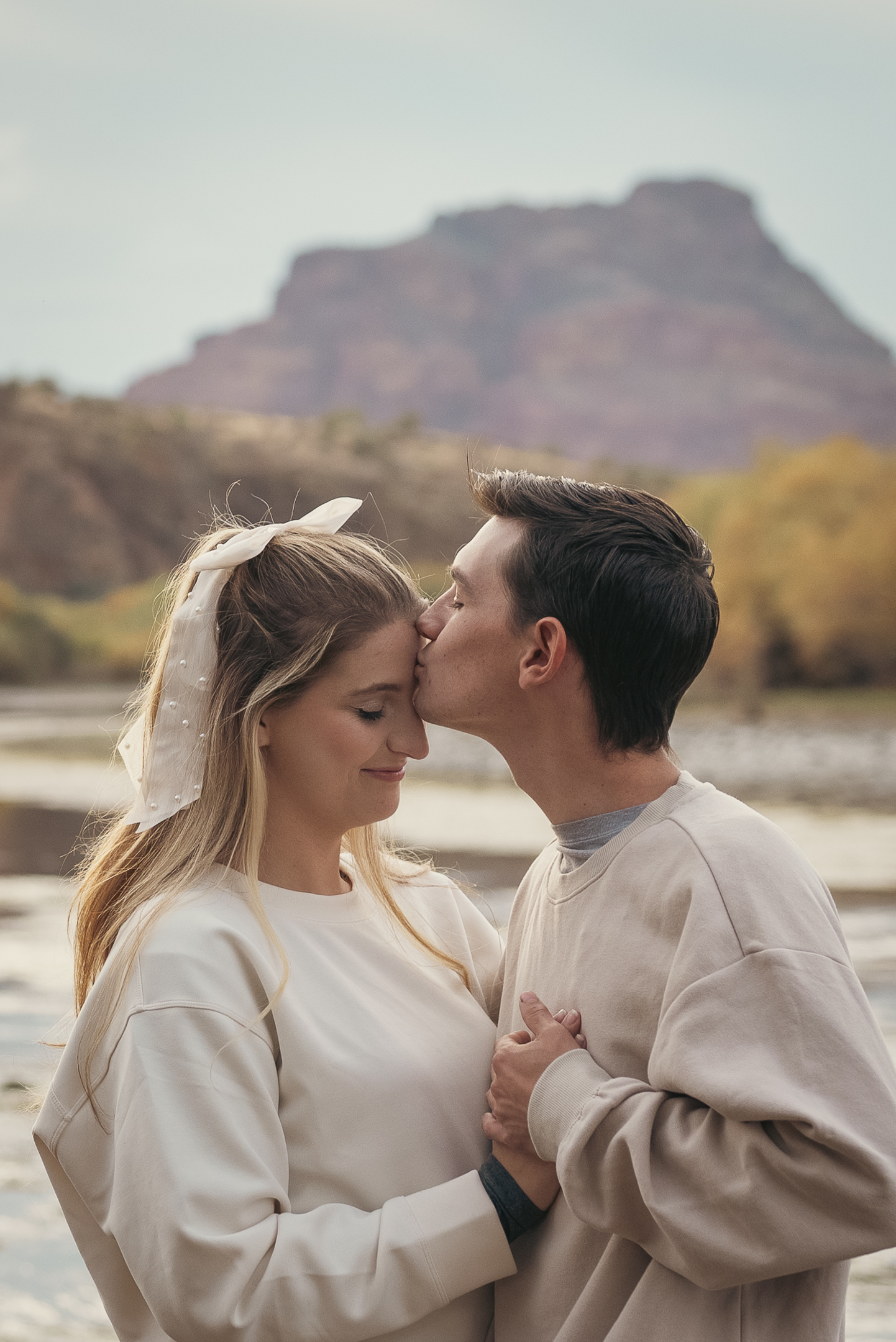 Engaged couple embrace lovingly for photo session along the Lower Salt River in Arizona