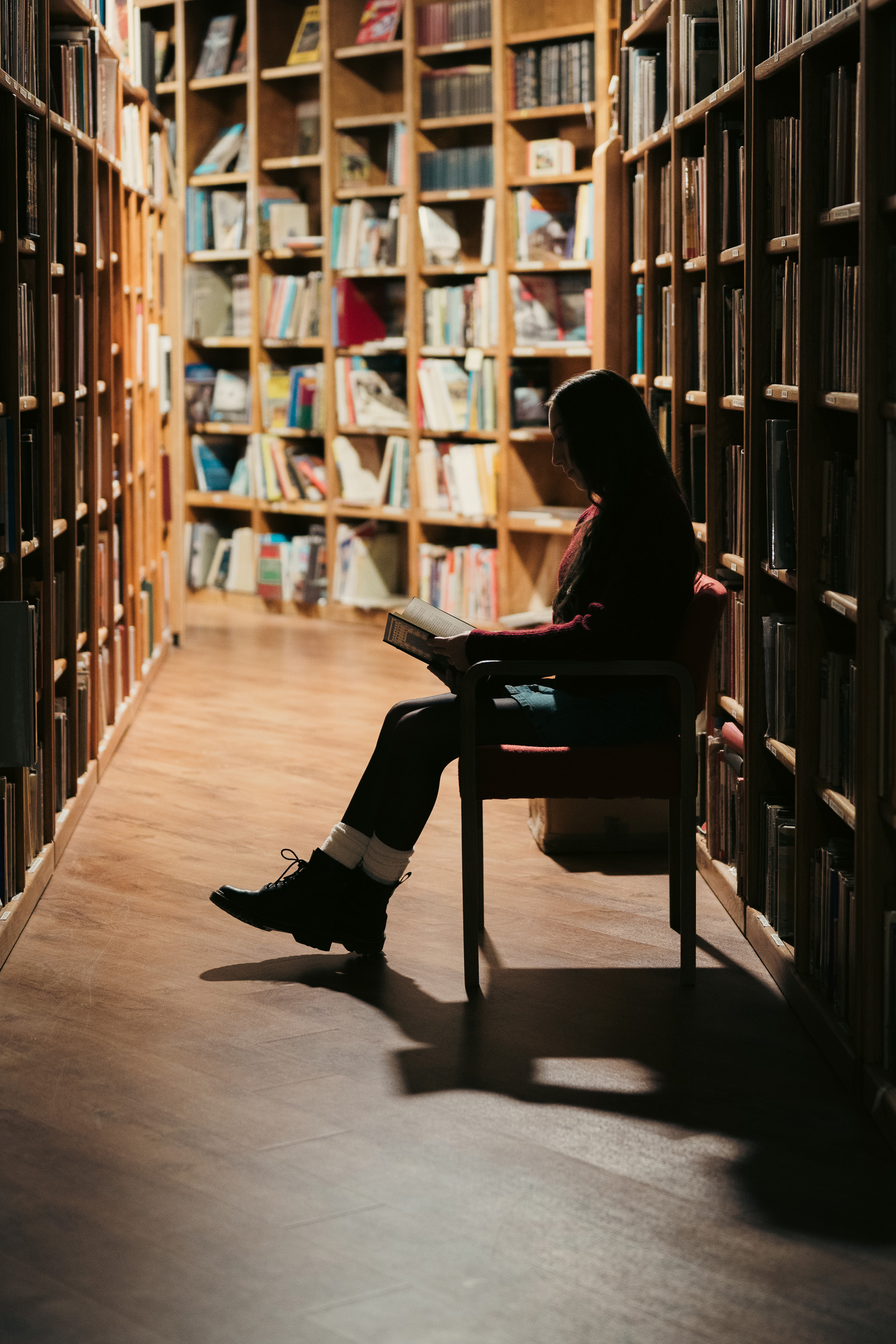 Girl sitting reading books in the Phoenix Book Gallery store.