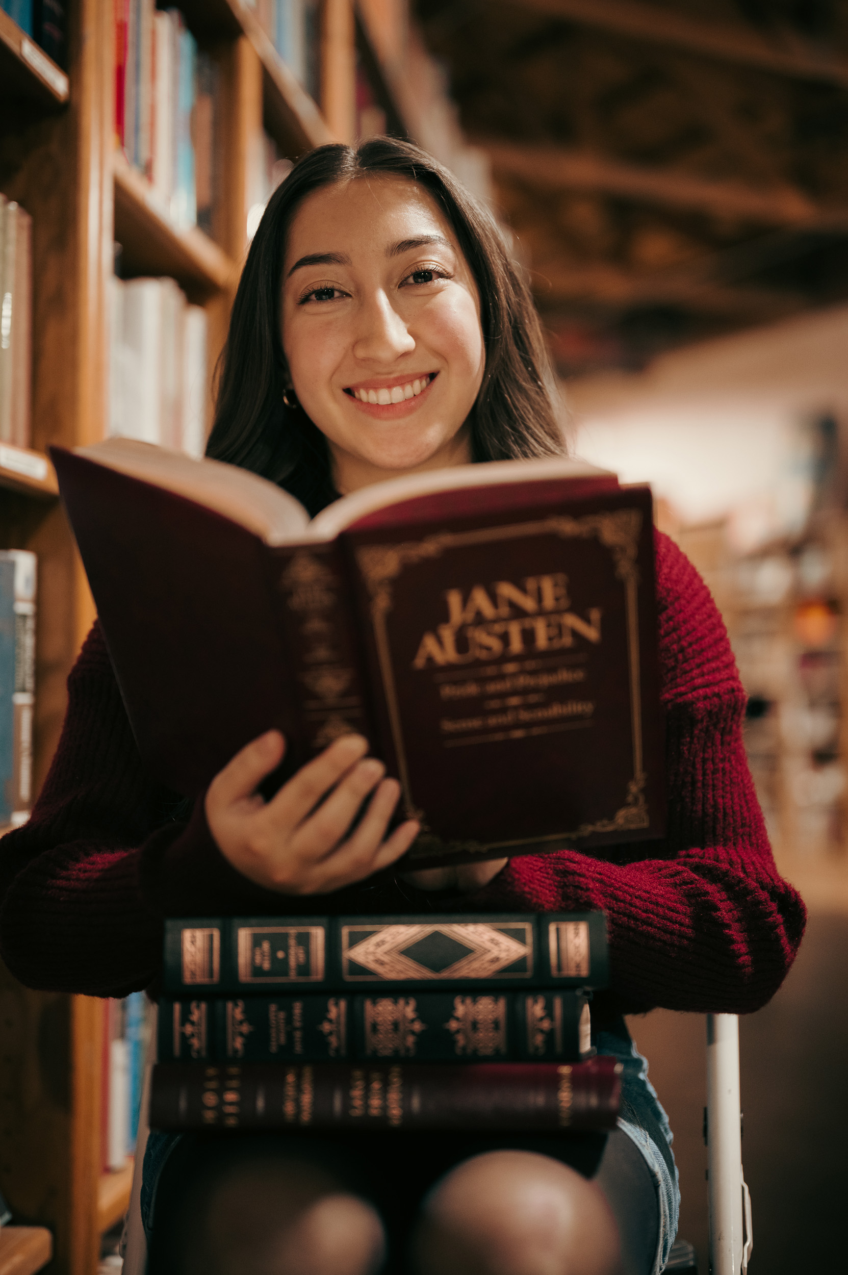 Girl sitting reading Jane Austen book in the Phoenix Book Gallery store.