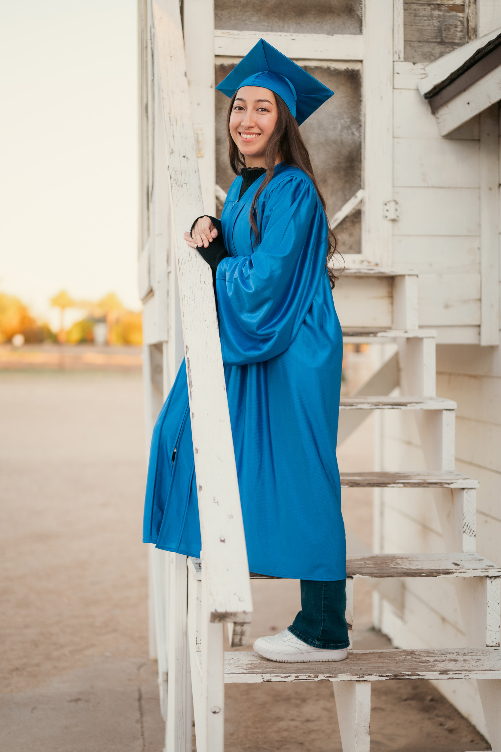 Senior portraits wearing cap and gown at Sahuaro Ranch in Glendale Arizona.