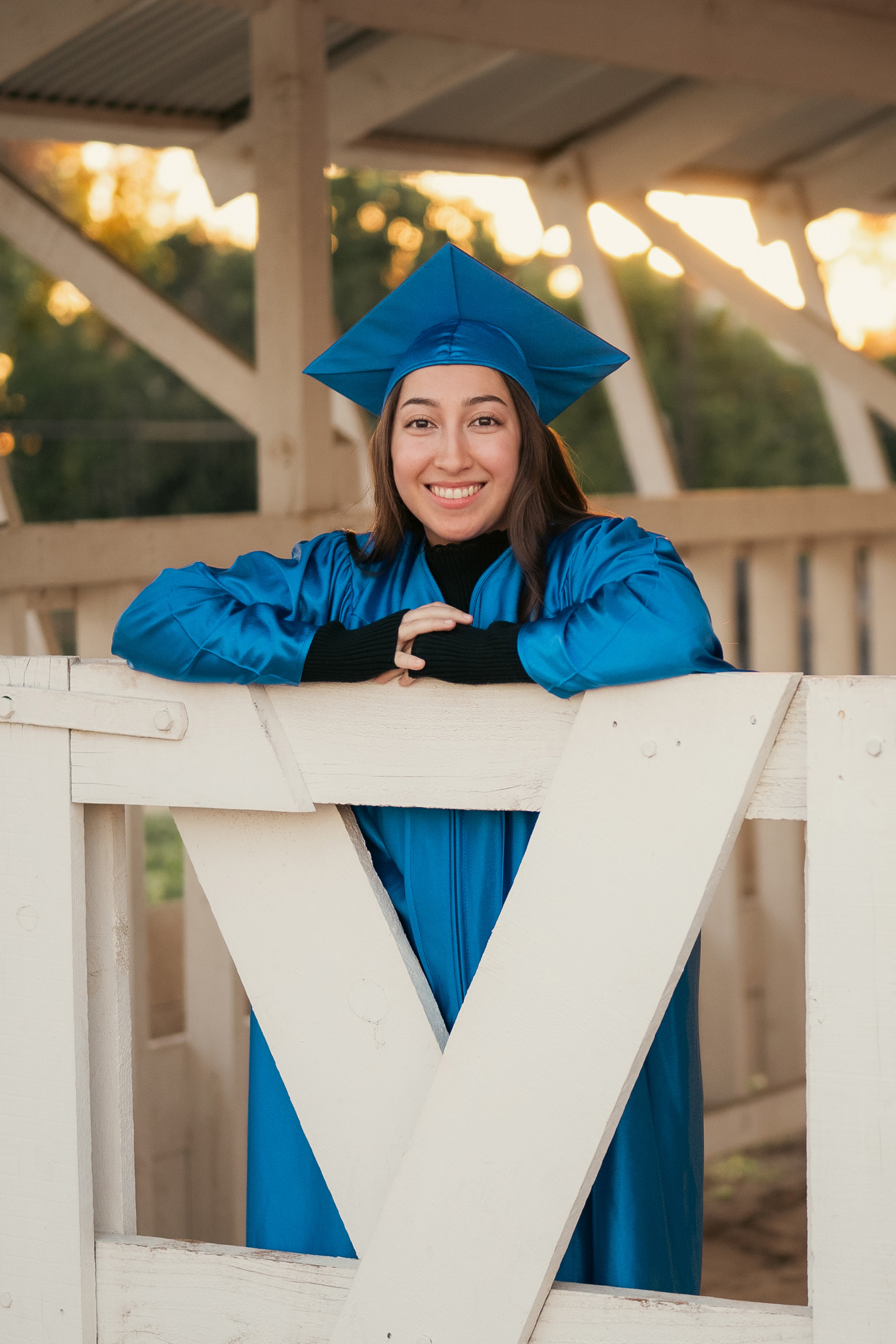 Senior portraits wearing cap and gown at Sahuaro Ranch in Glendale Arizona.