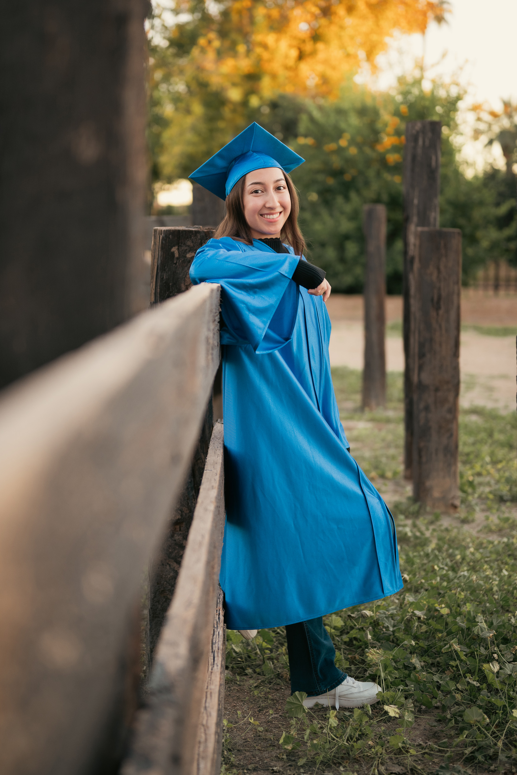 Senior portraits wearing cap and gown at Sahuaro Ranch in Glendale Arizona.