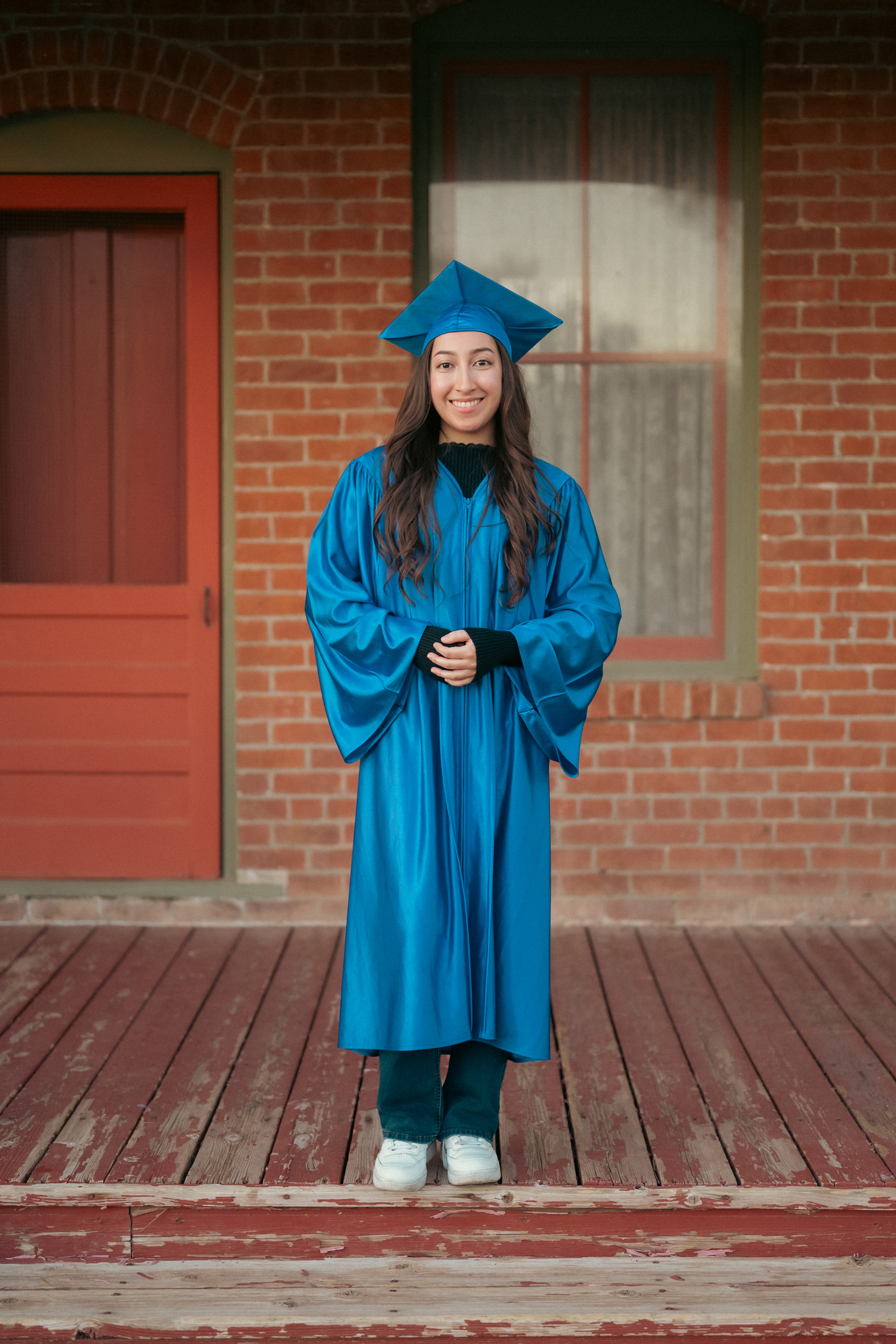 Senior portraits wearing cap and gown at Sahuaro Ranch in Glendale Arizona.