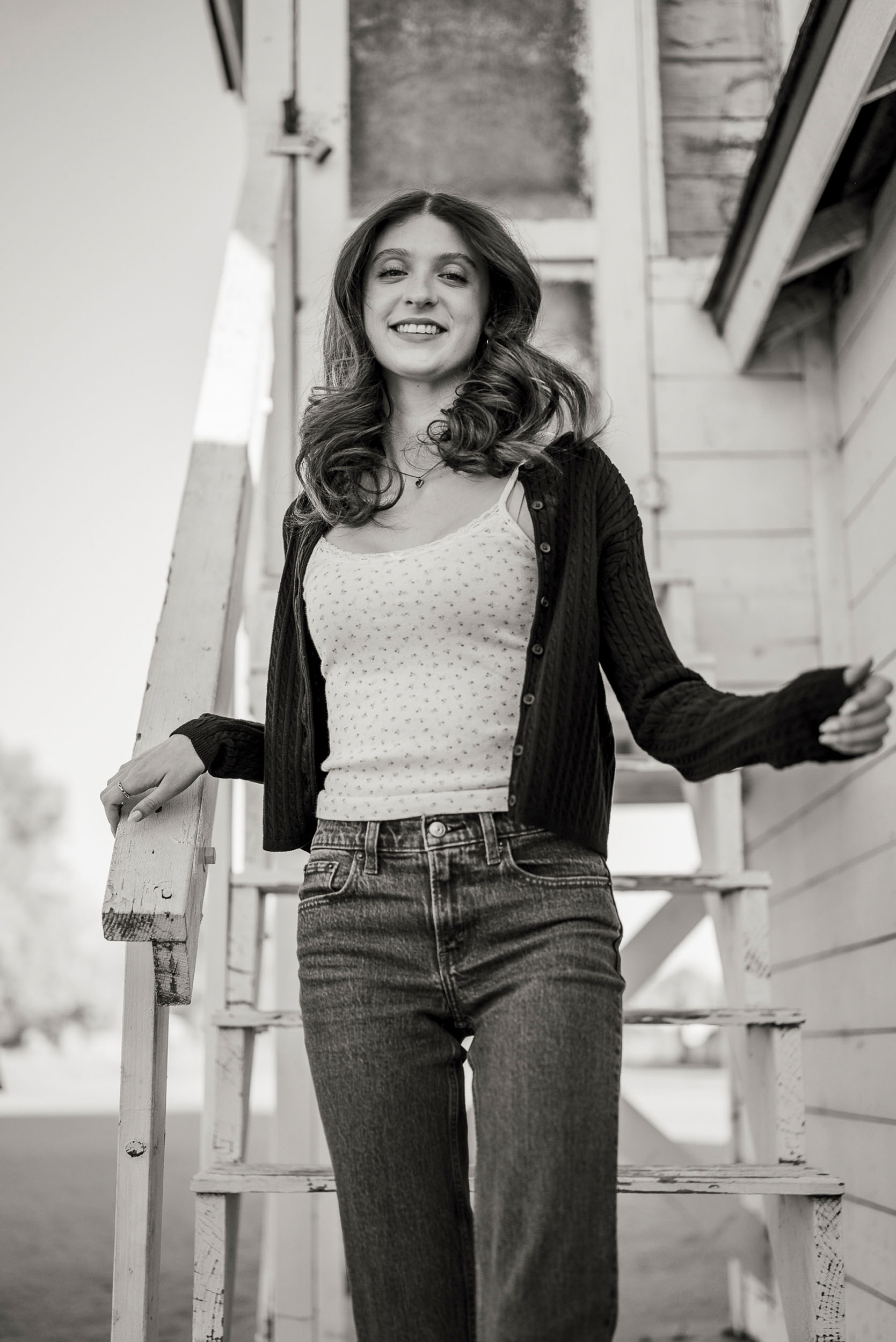 Senior photo of young woman taken on stairs of farm house in Sahuaro Ranch Park in Glendale, AZ.