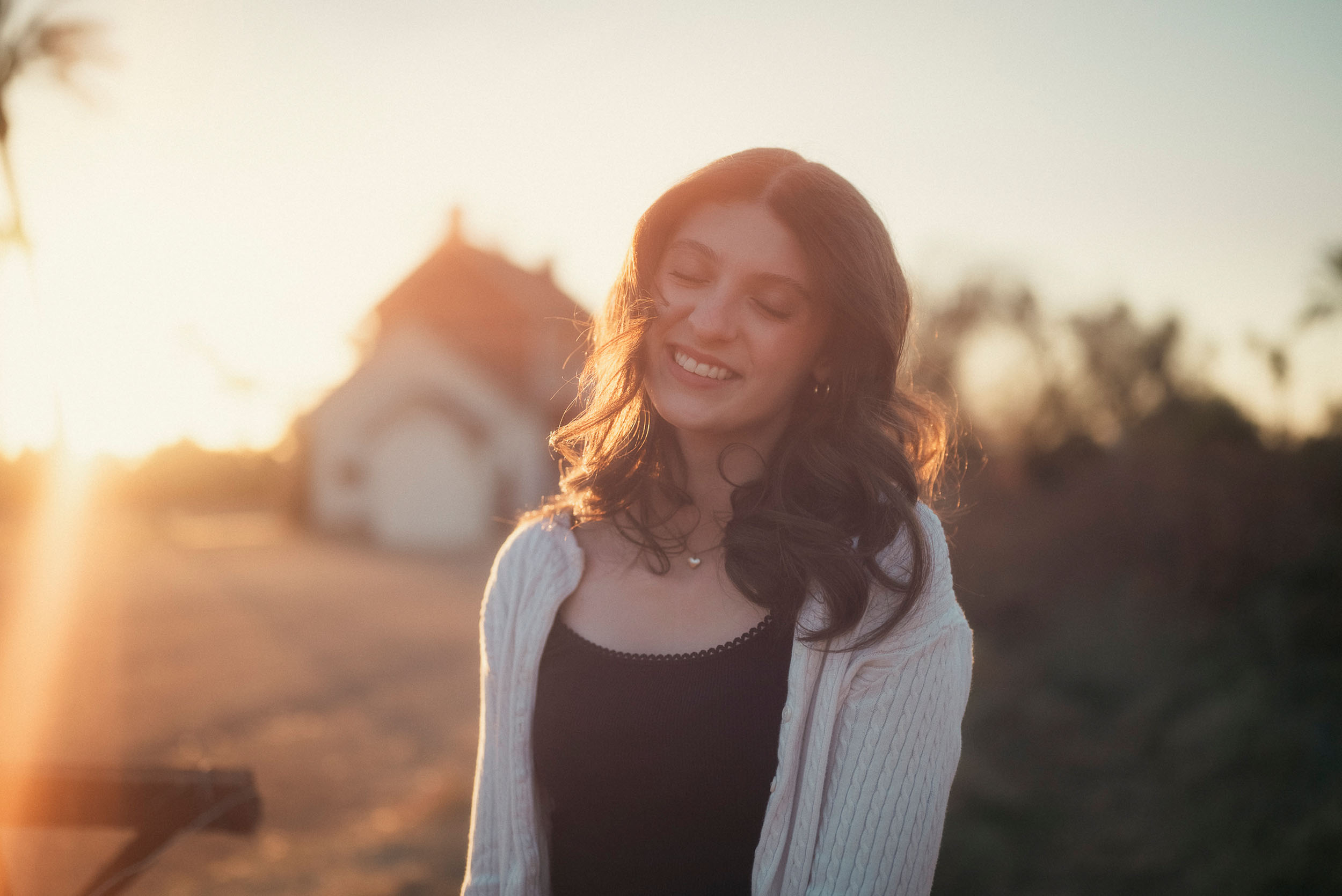 Senior photo of young woman at Sahuaro Ranch Park Glendale, AZ at golden hour.
