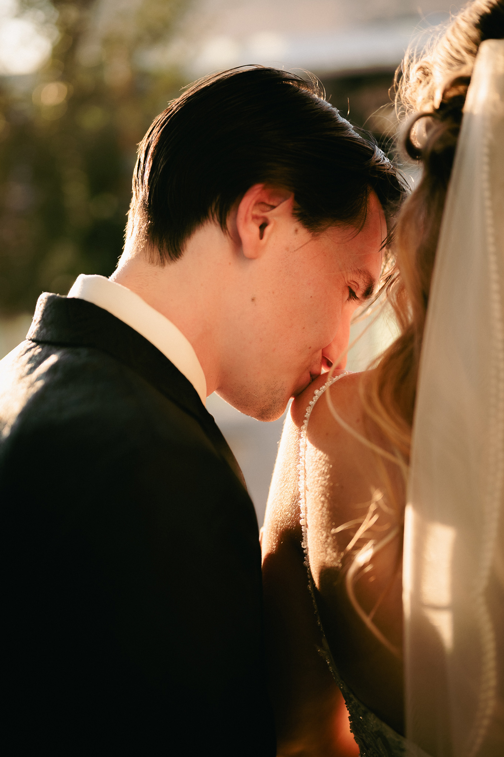 groom kissing bride's shoulder golden hour Mesa, Arizona Main St. Tre Bella.