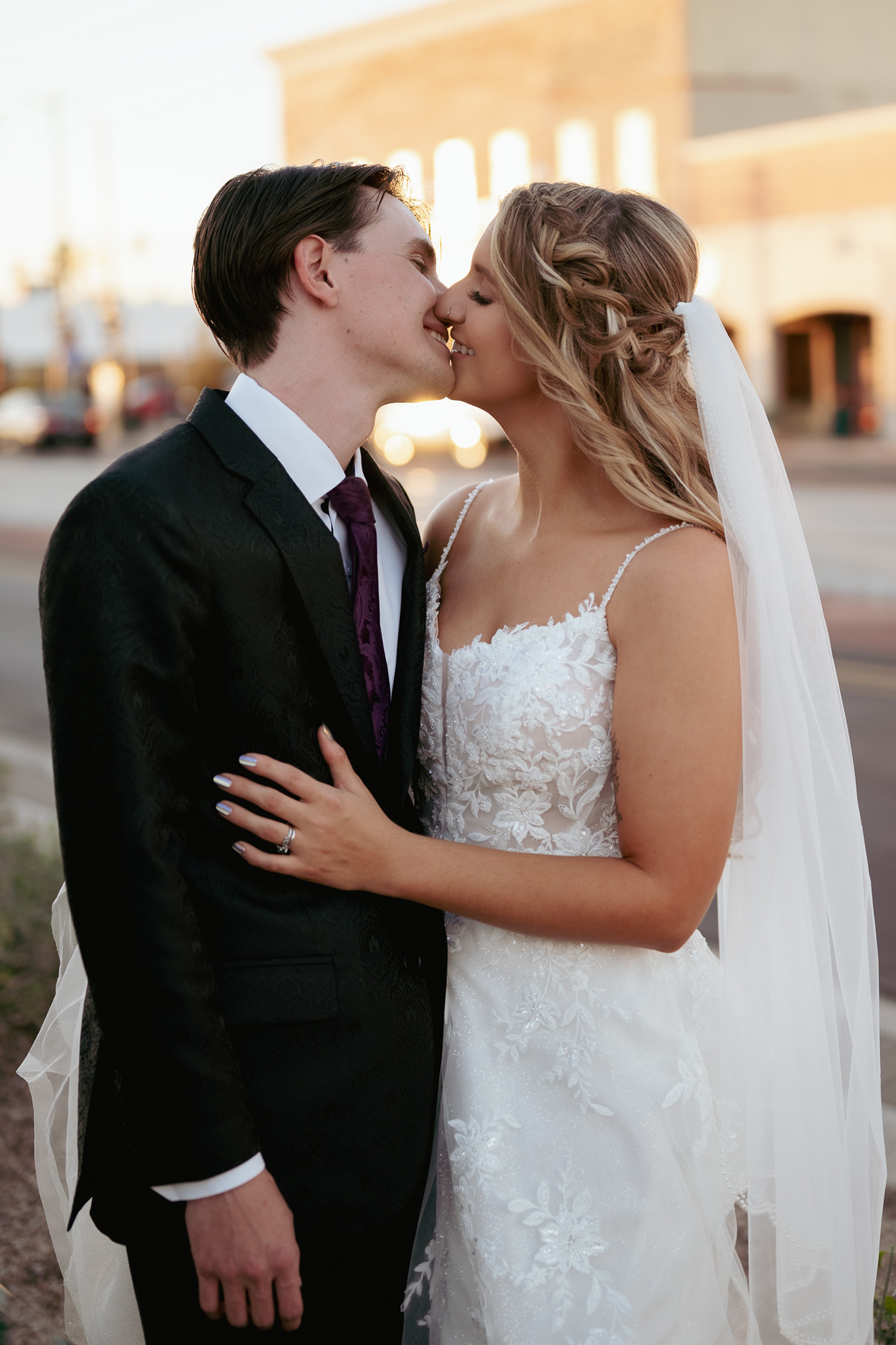 Bride and Groom kissing at golden hour Mesa, Arizona Main St. Tre Bella.