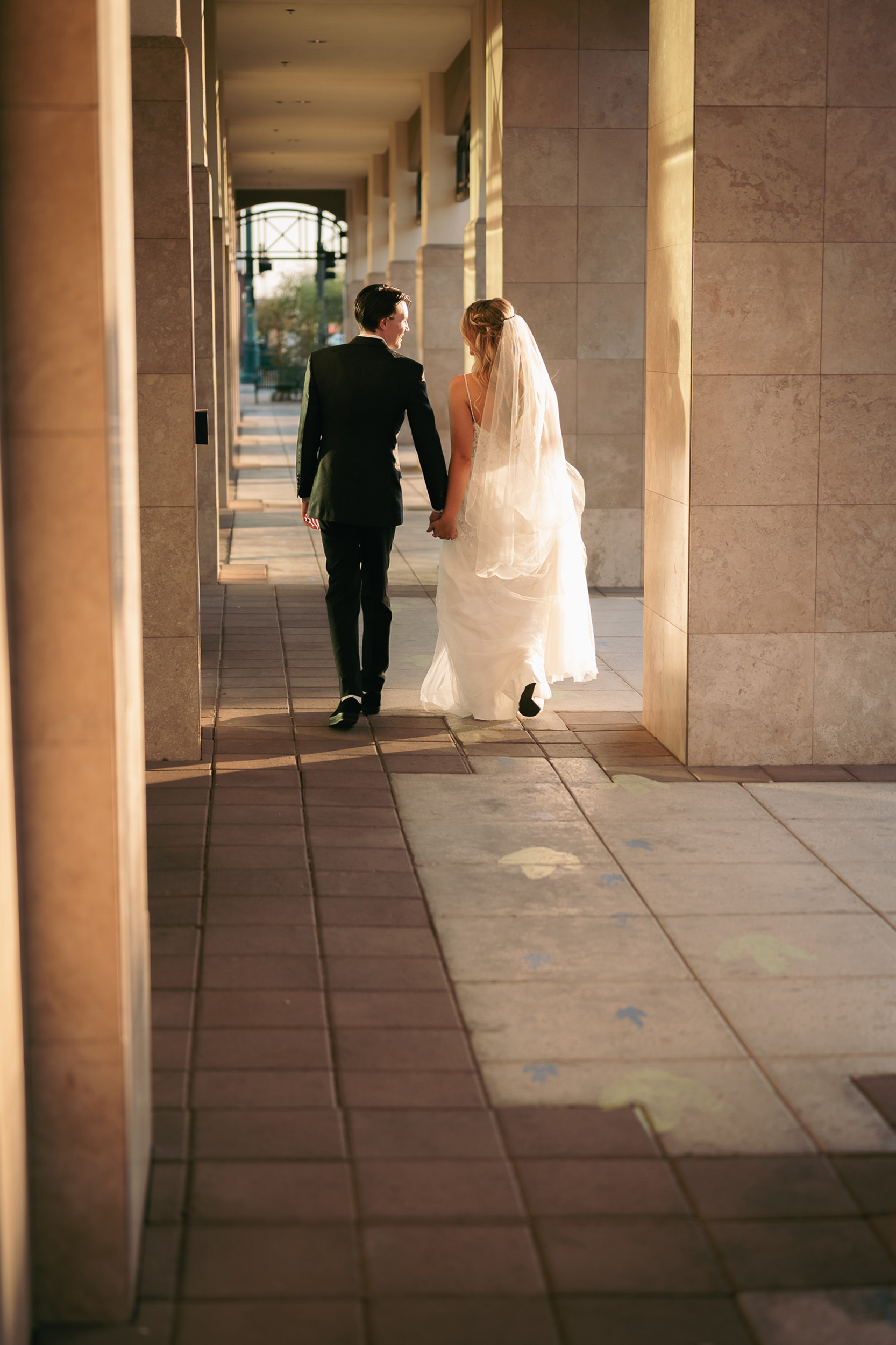 Bride and Groom walking holding hands Mesa, Arizona Main St. Tre Bella.