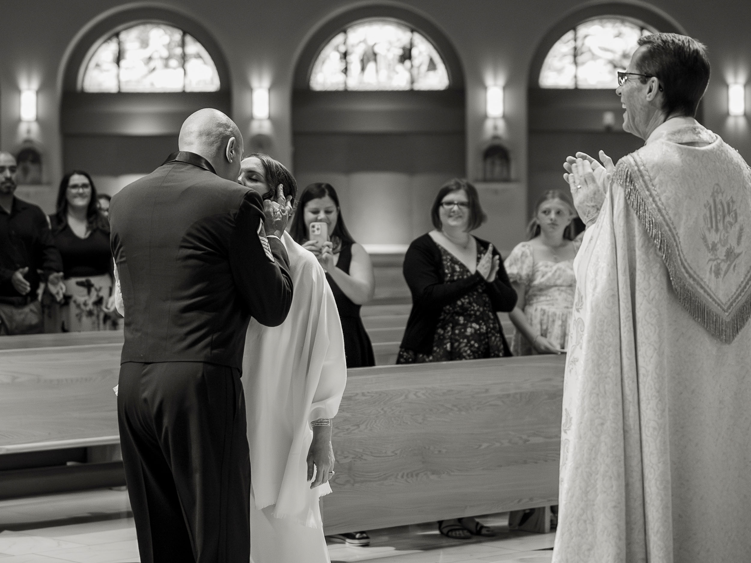 bride and groom kiss wedding at St. Clare of Assisi catholic church Surprise, AZ