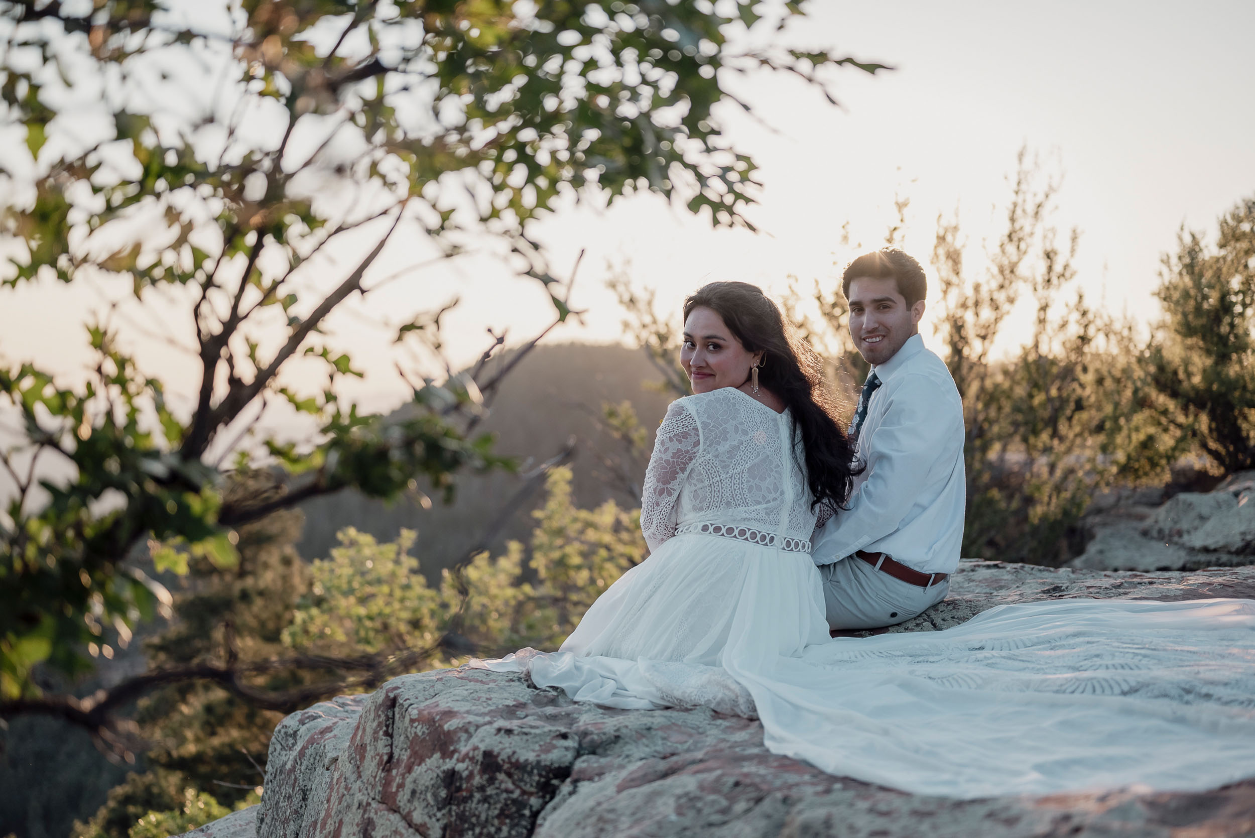 Bride and groom sitting cliffside during elopement wedding at the Mogollon Rim in Payson, Arizona