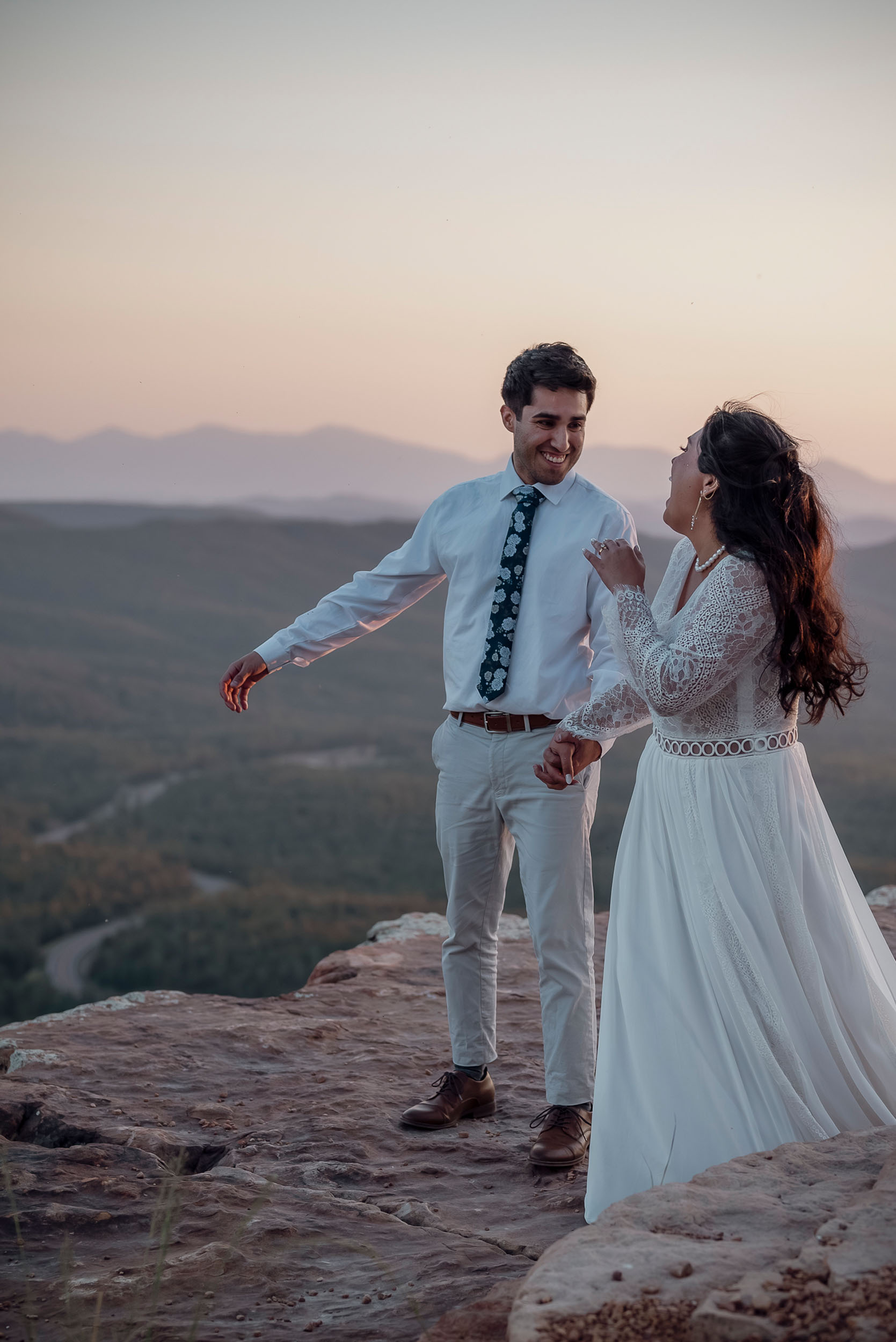 Bride and groom laughing celebrating during elopement wedding at the Mogollon Rim in Payson, Arizona