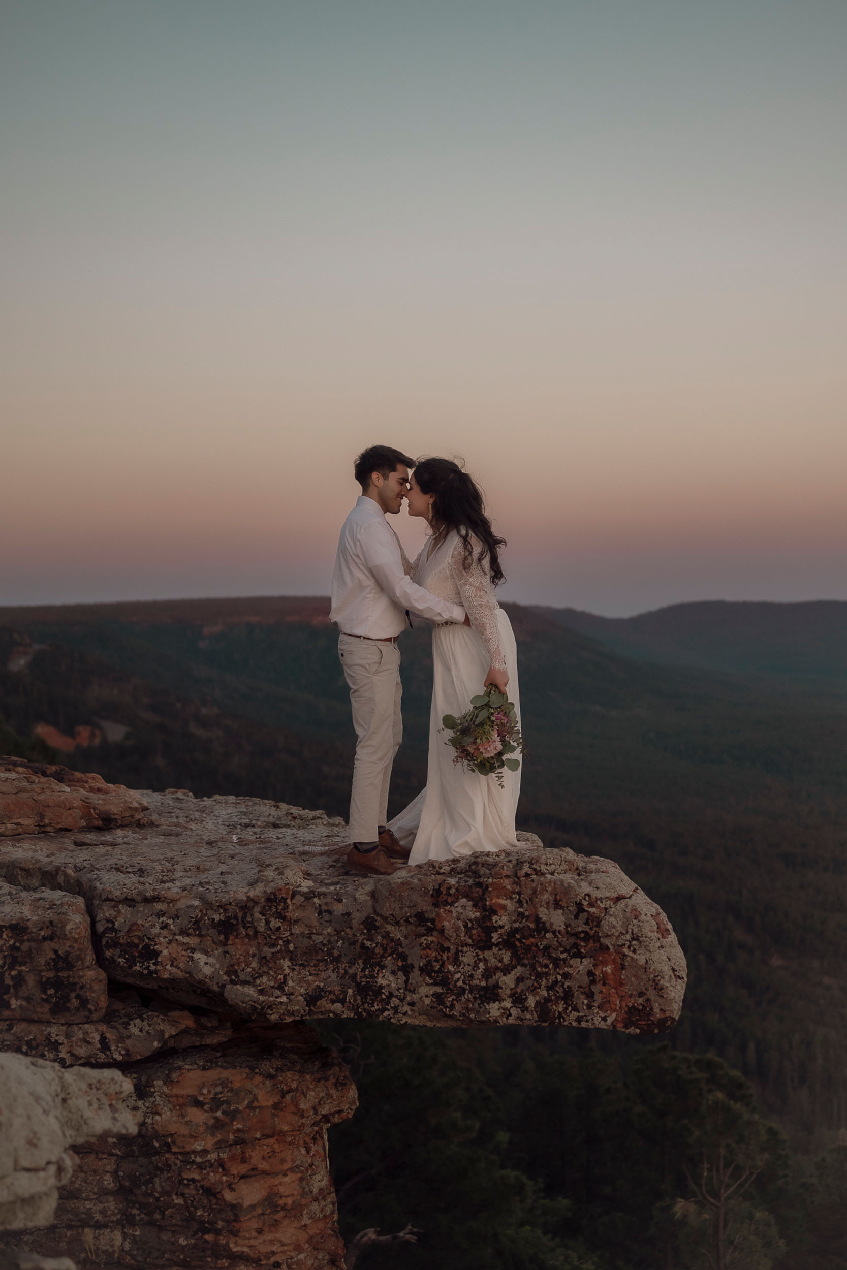 Bride and groom kiss during elopement wedding at the Mogollon Rim in Payson, Arizona