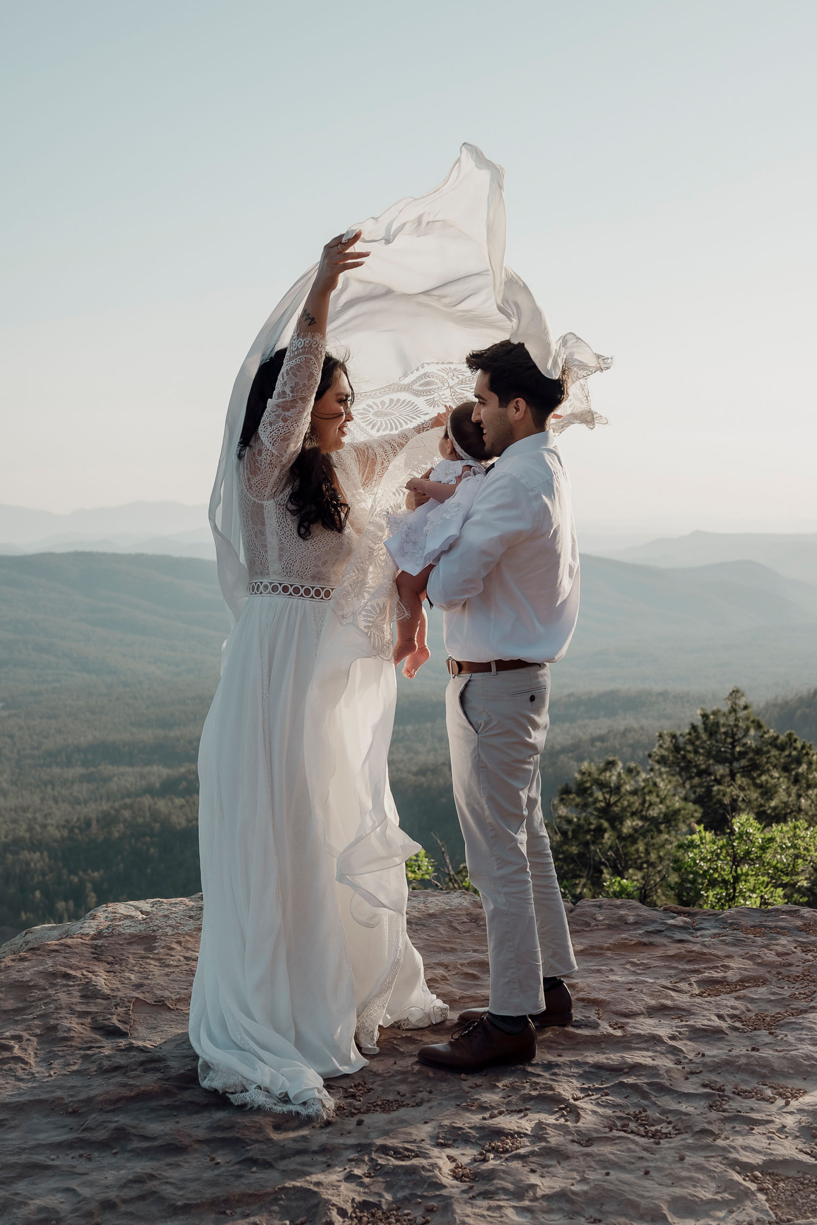 Bride and groom with baby during elopement wedding at the Mogollon Rim in Payson, Arizona beautiful forest mountain views