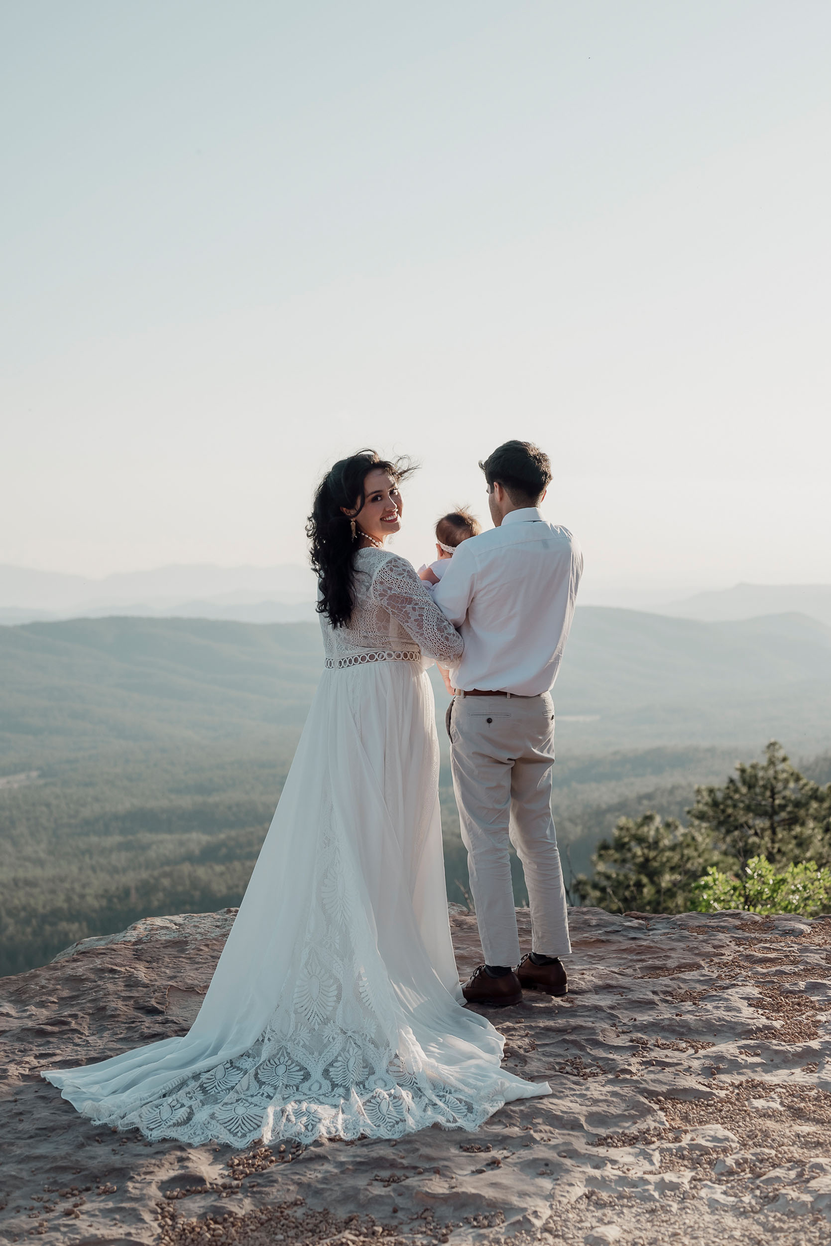 Bride and groom with their baby during elopement wedding at the Mogollon Rim in Payson, Arizona