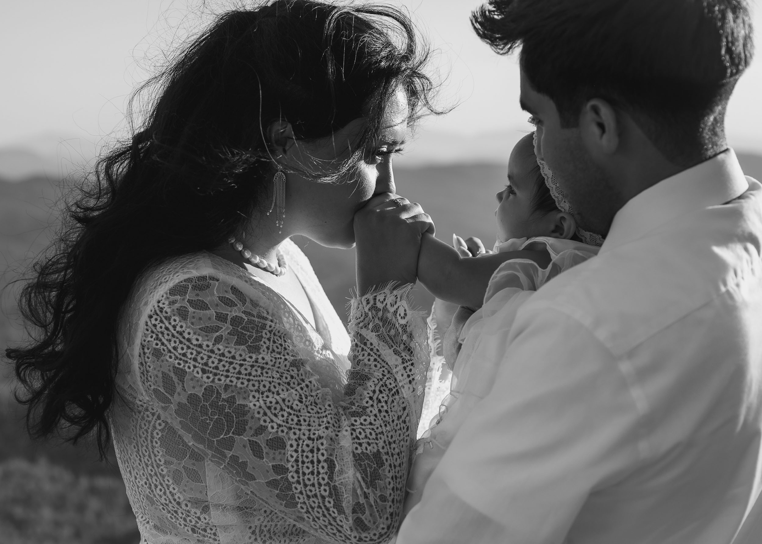 Bride and groom with their child during elopement wedding at the Mogollon Rim in Payson, Arizona