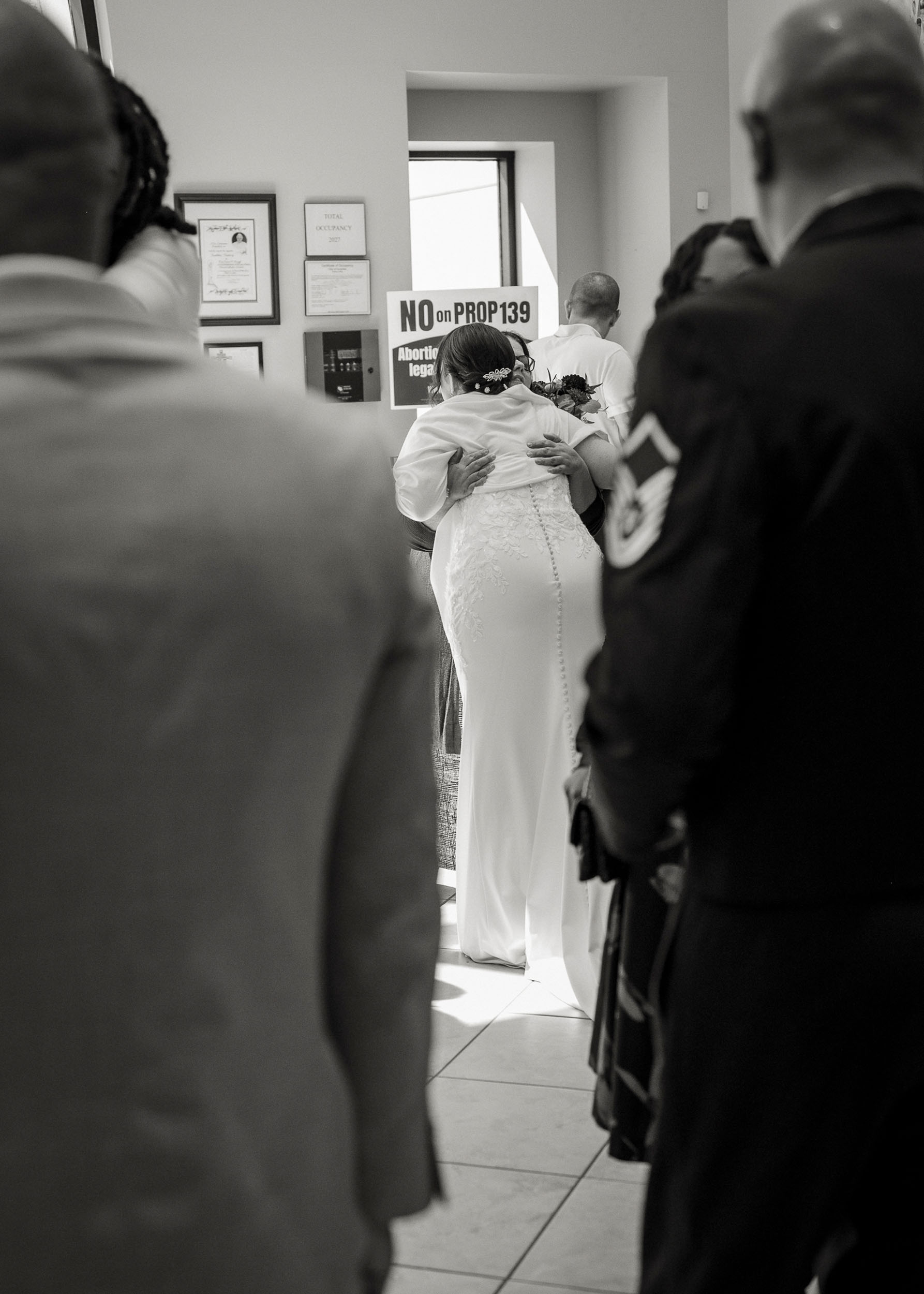 Bride hugging guest at wedding at St. Clare of Assisi catholic church Surprise, AZ