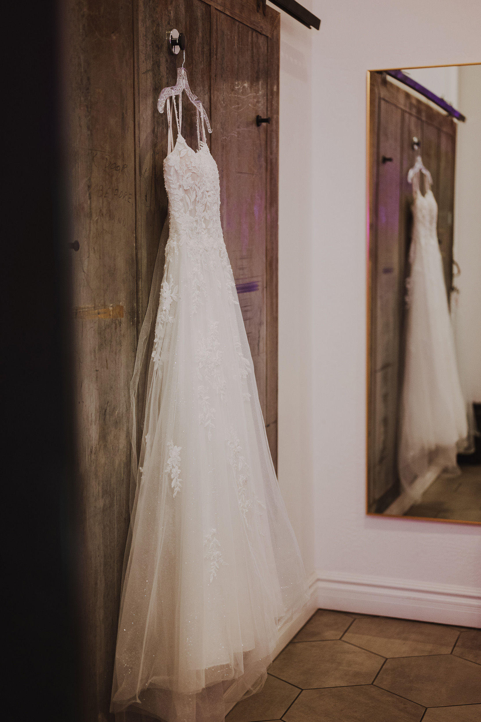 Wedding gown hanging in dressing room at Tre Bella Arizona.