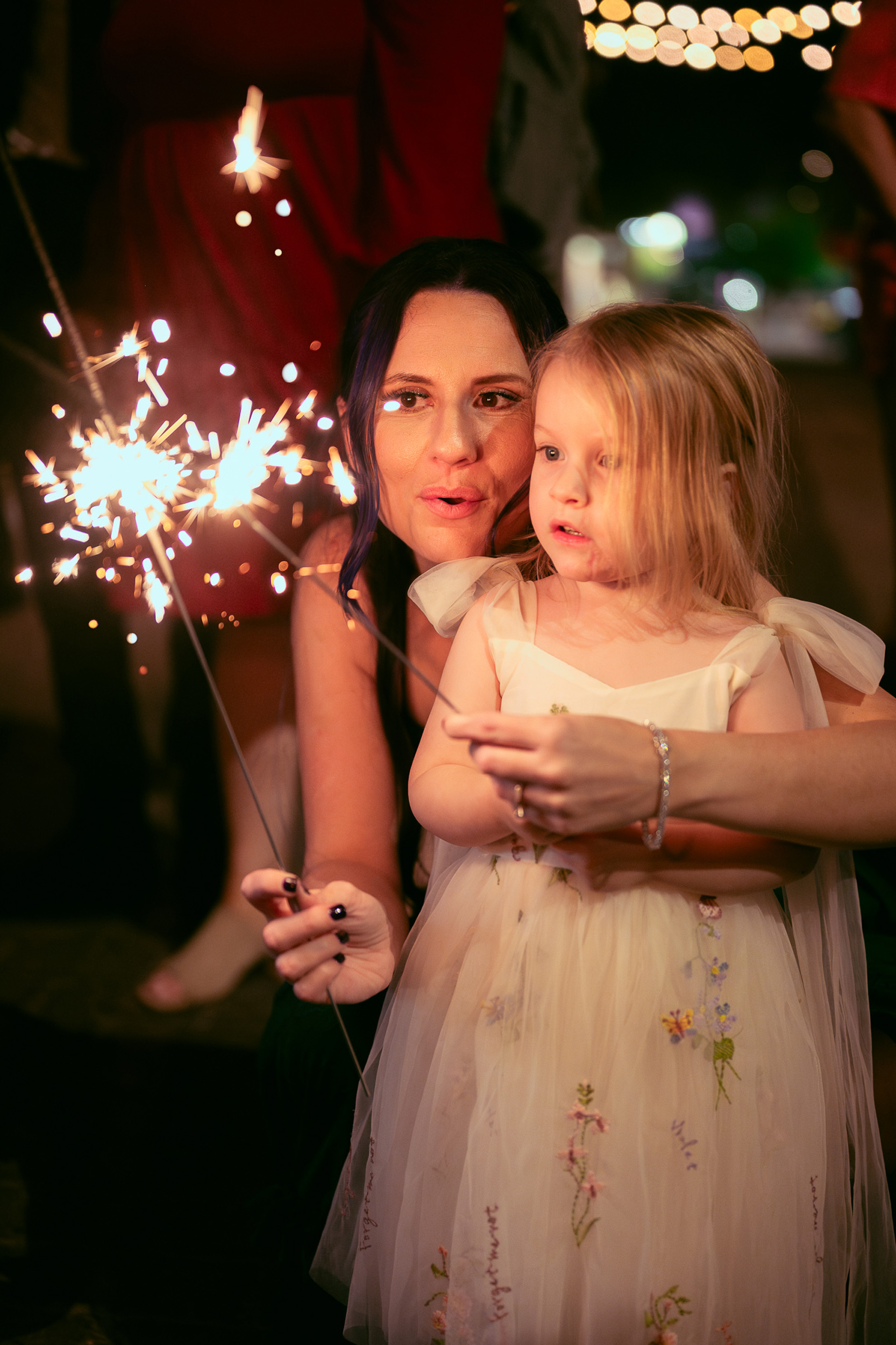 Bridesmaids hold sparkler after wedding reception at Tre Bella Mesa Arizona.