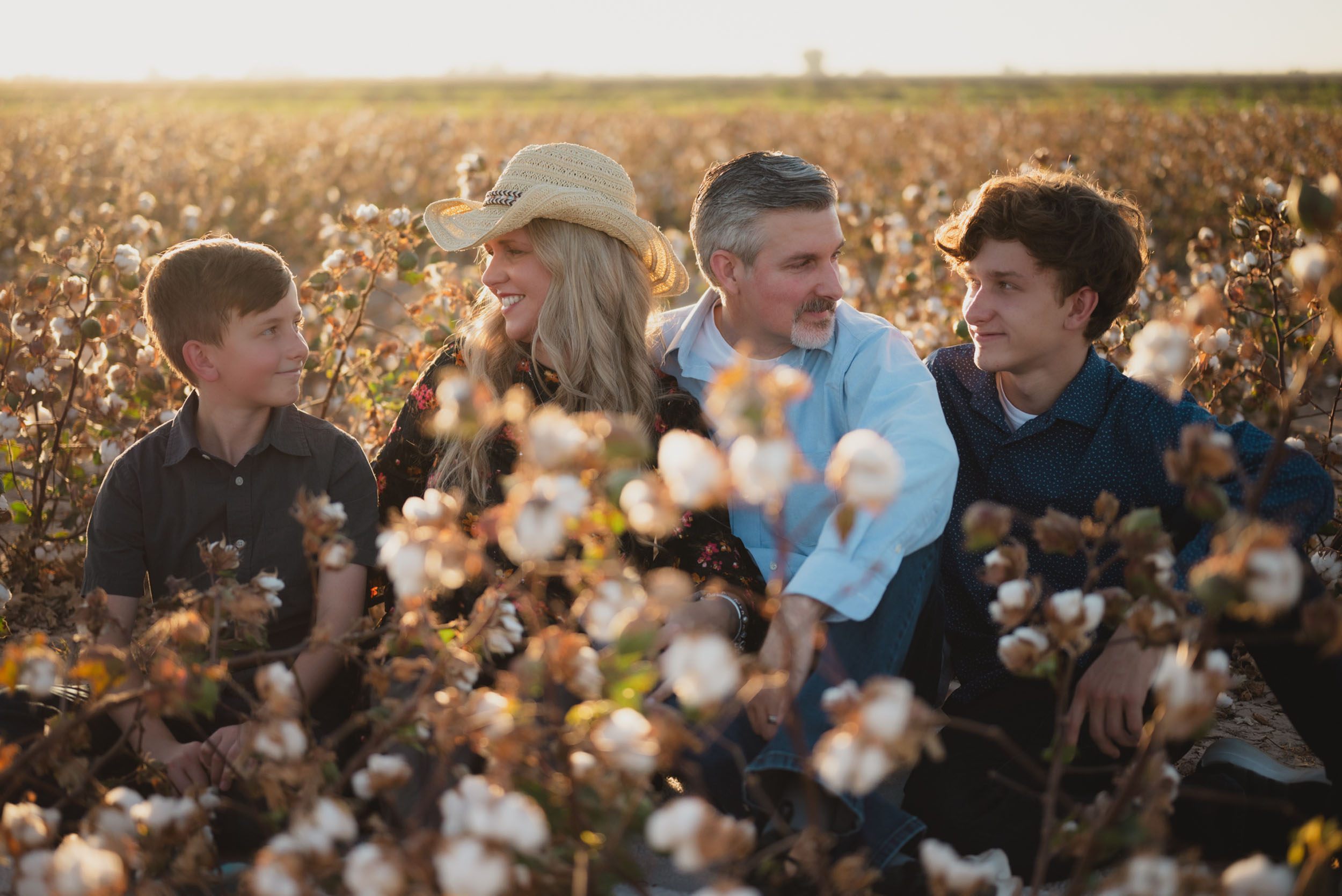 Portrait of family sitting in a cotton field at Rocker 7 Farm in Buckeye.