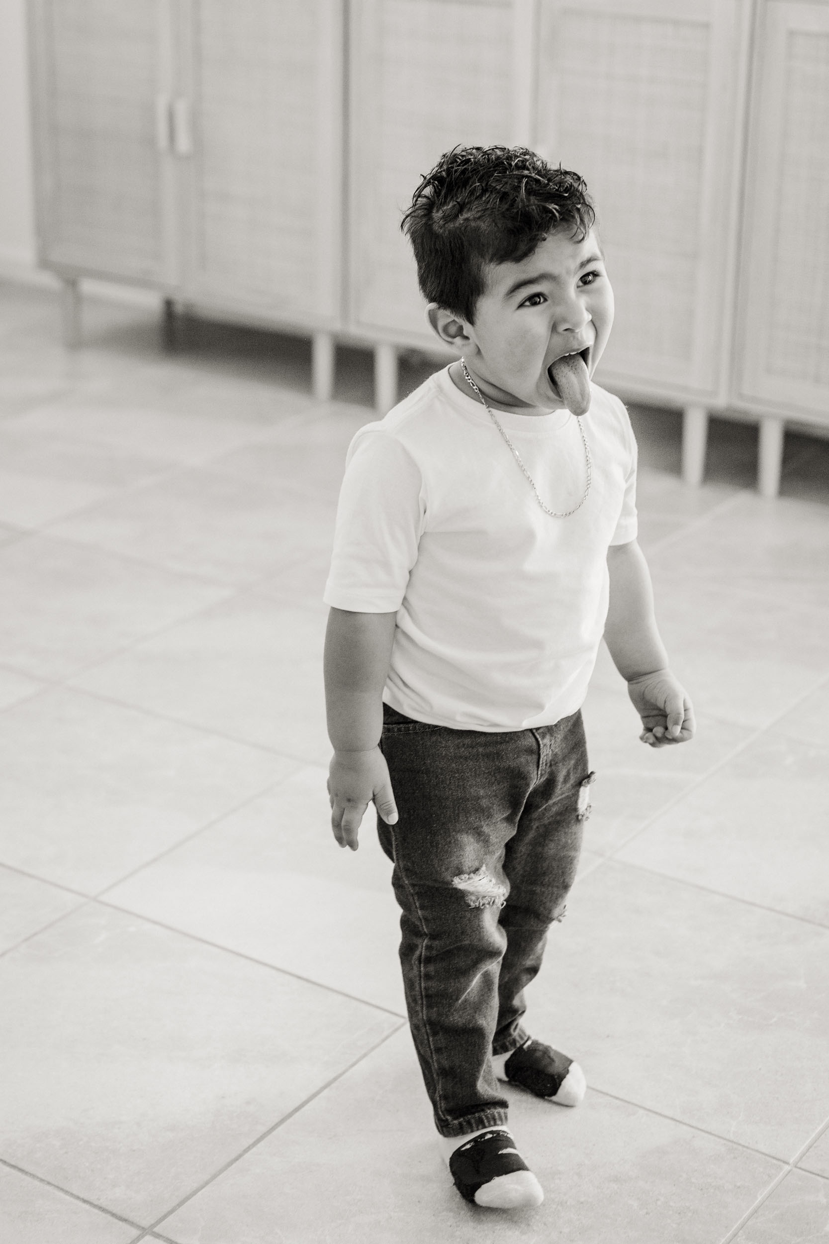 young boy playfully sticking out his tongue