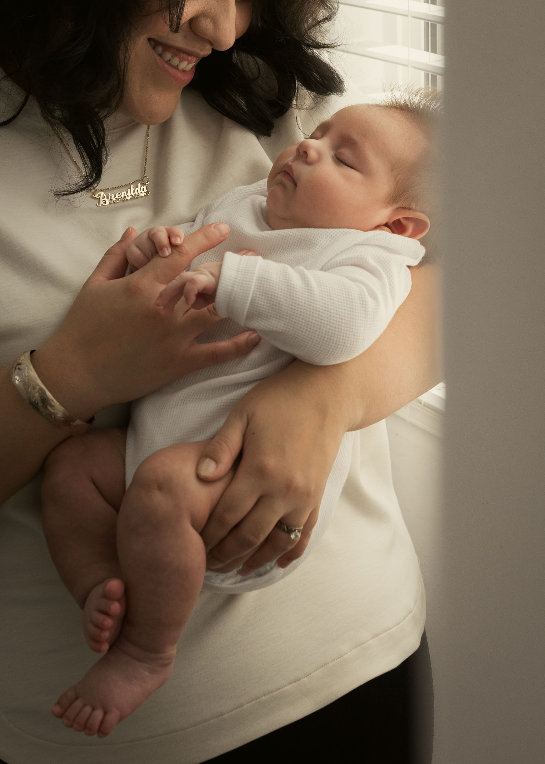 mother cradling sleeping infant son
