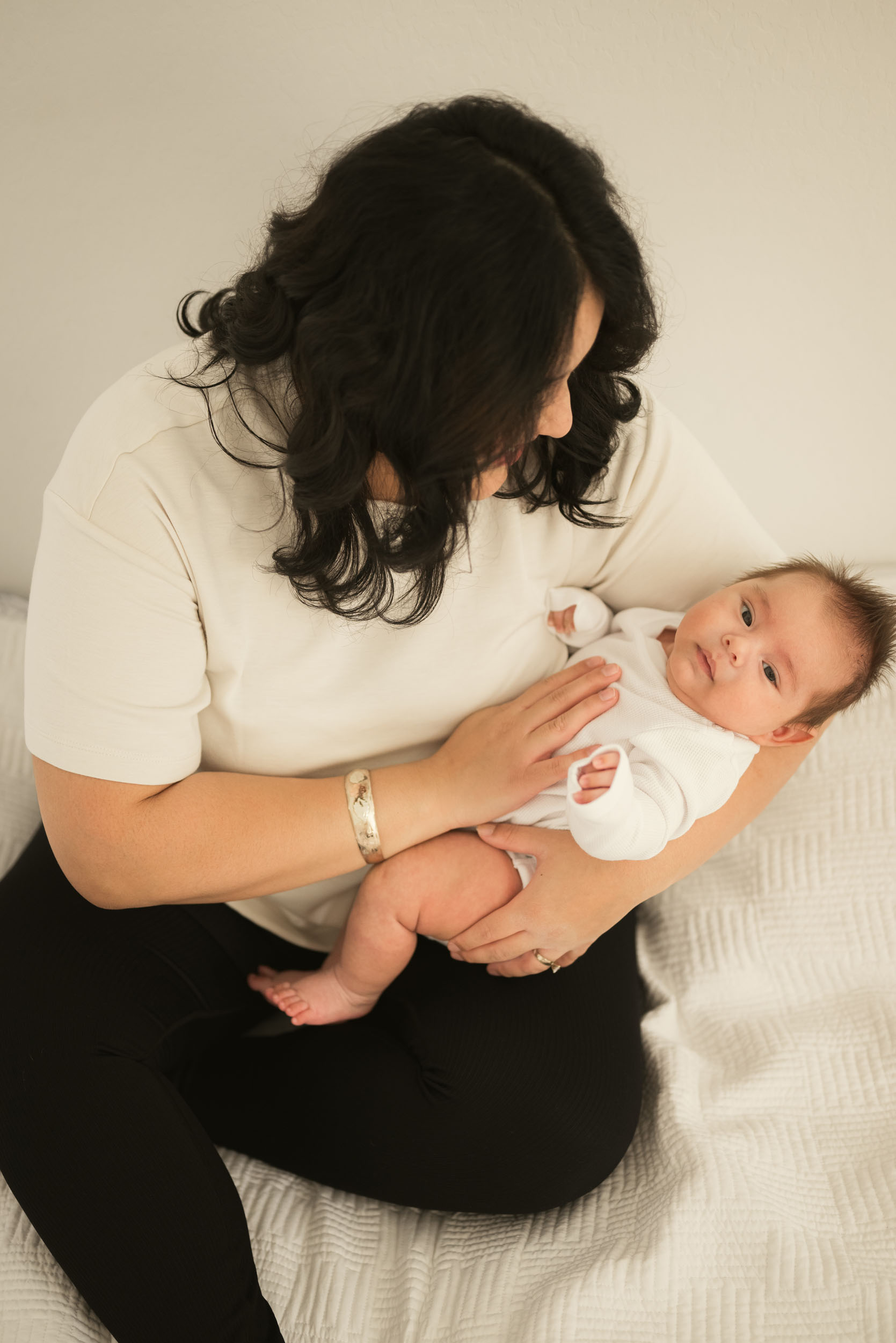 mother cradling newborn baby during lifestyle photo session