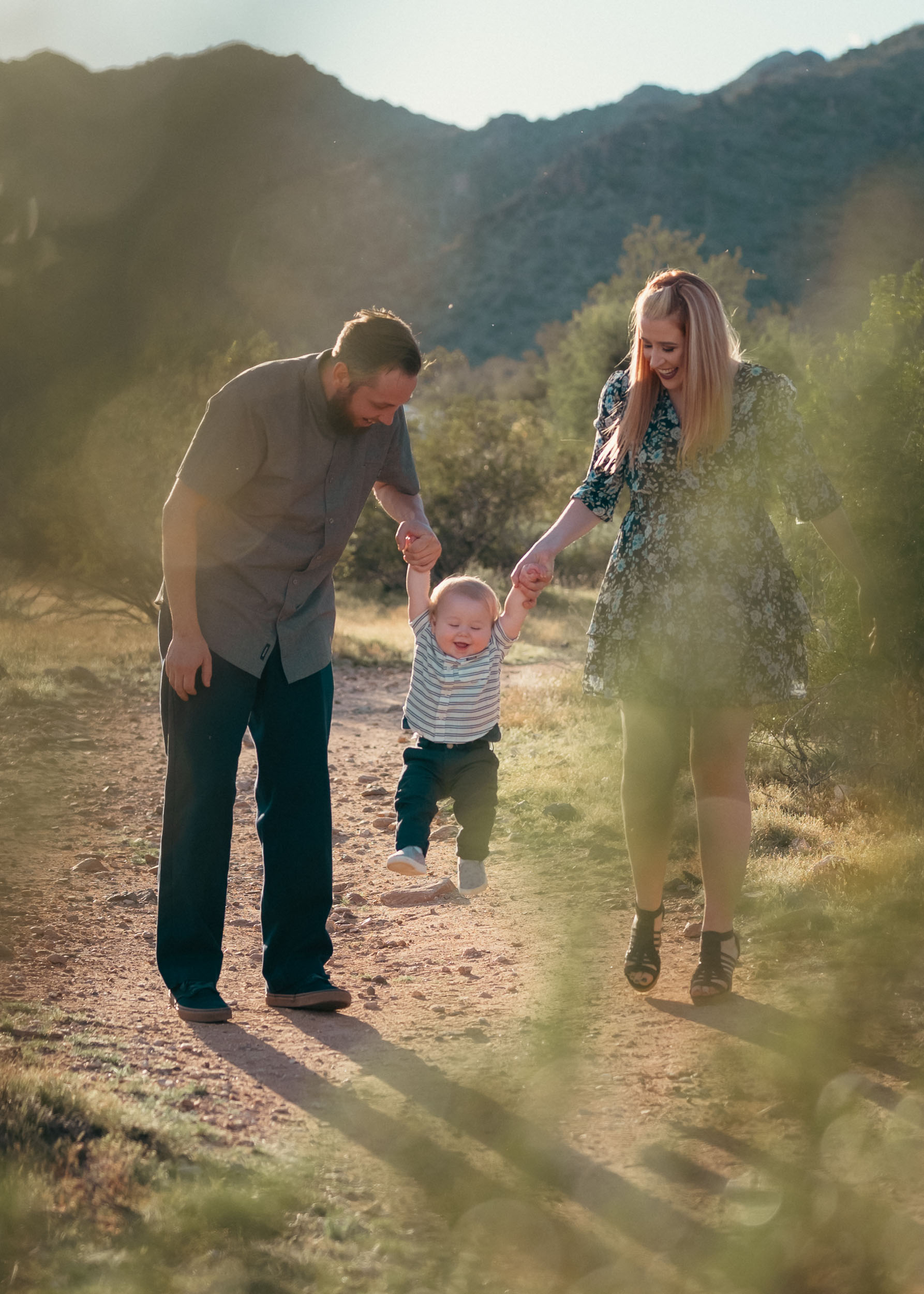 family walking and holding hands on a trail at White Tank Mountains in Surprise, Arizona