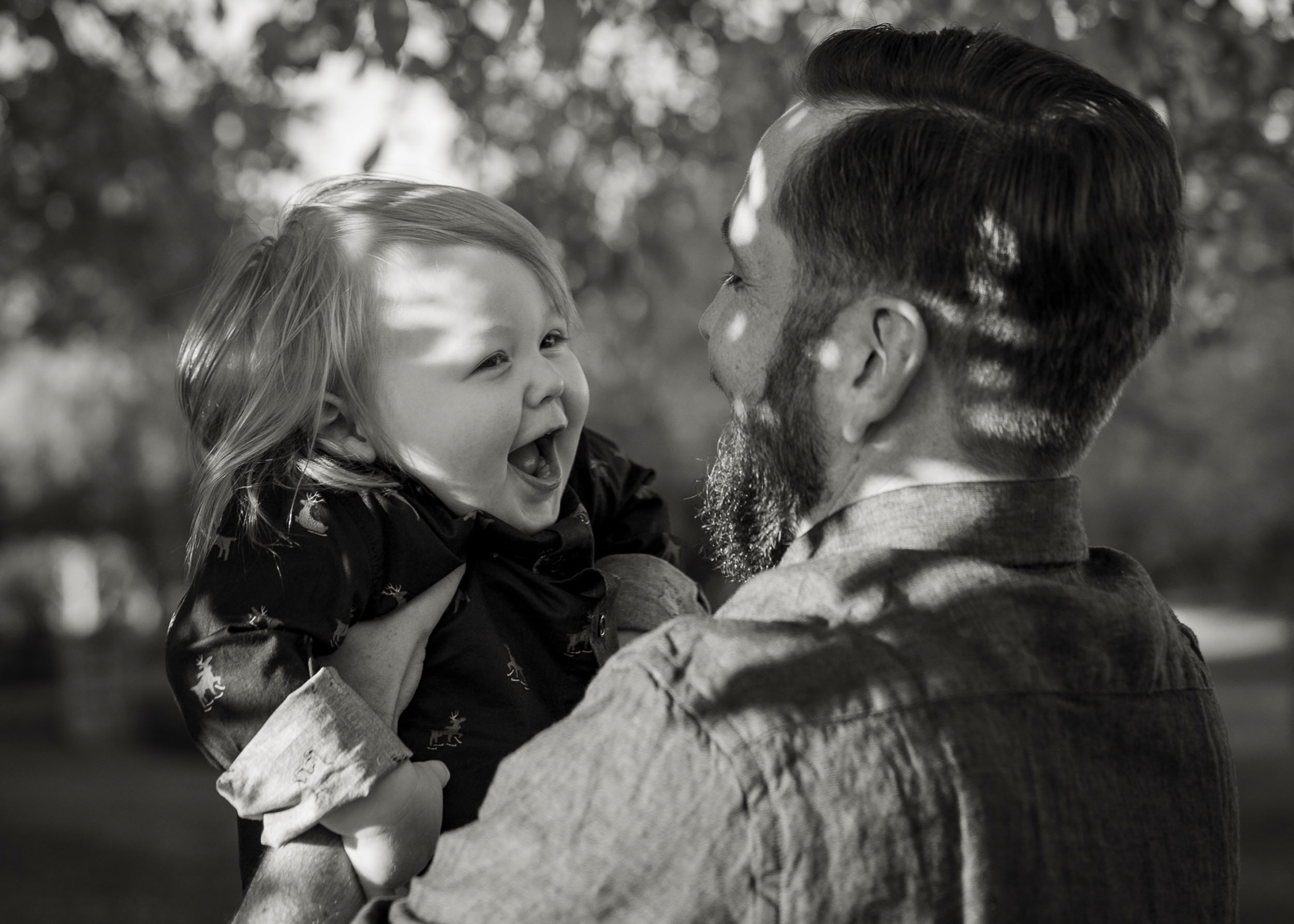 father holding laughing son in Marley Park, Arizona