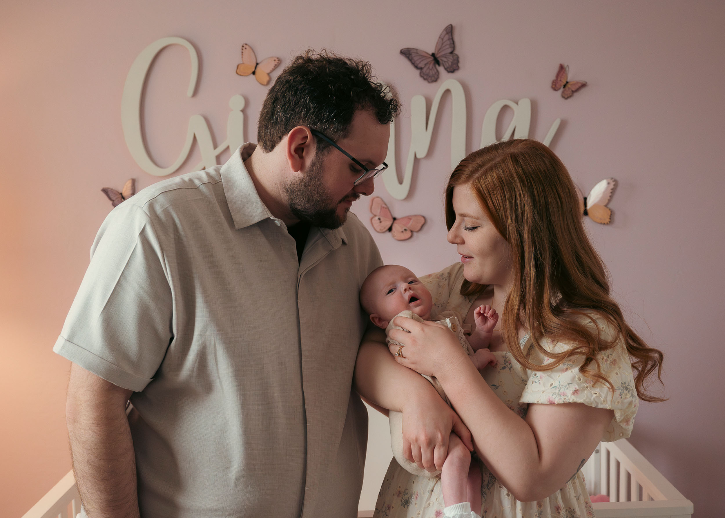 family holding newborn baby during lifestyle photo session
