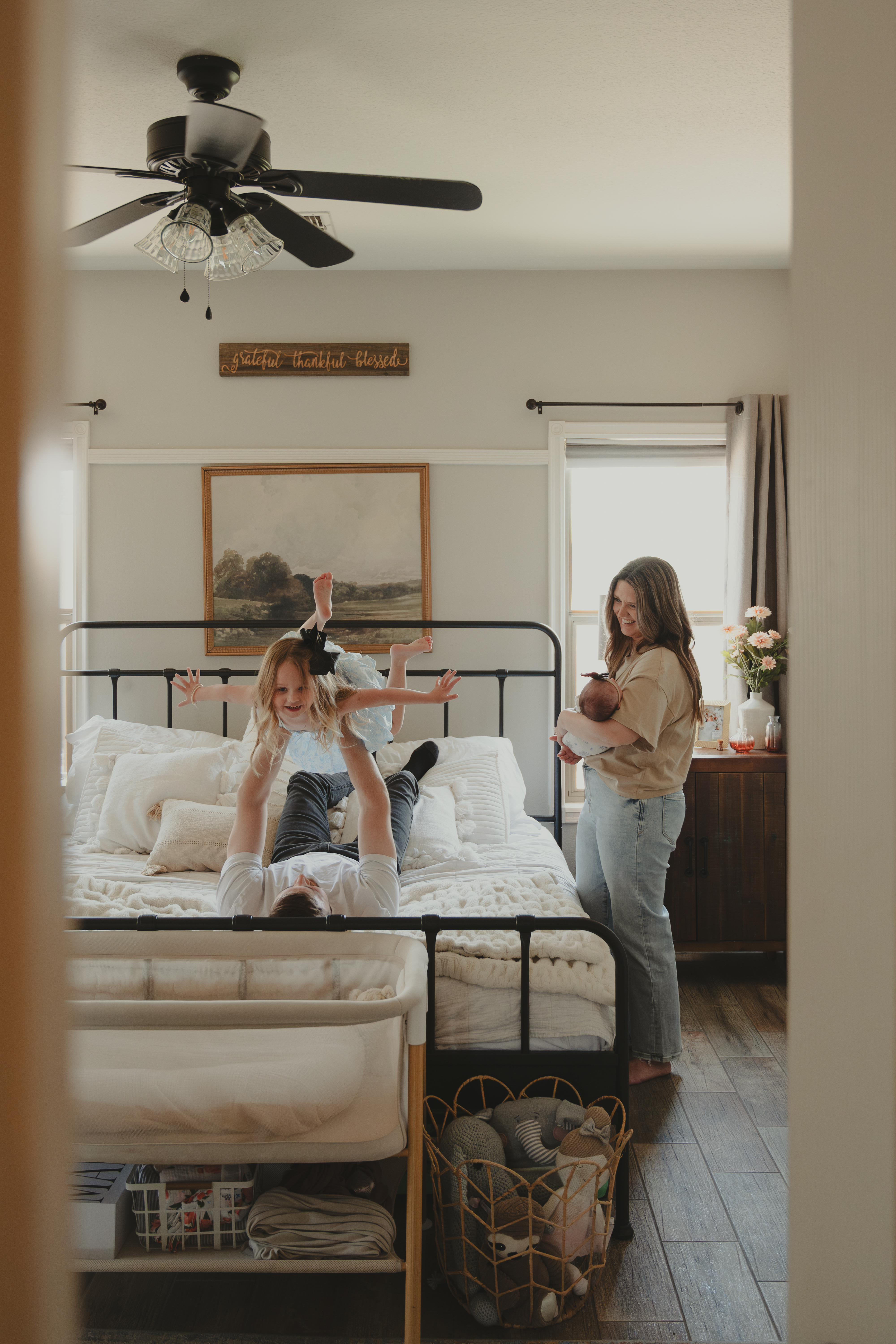 Family playing on bed during Lifestyle Family Portrait session.