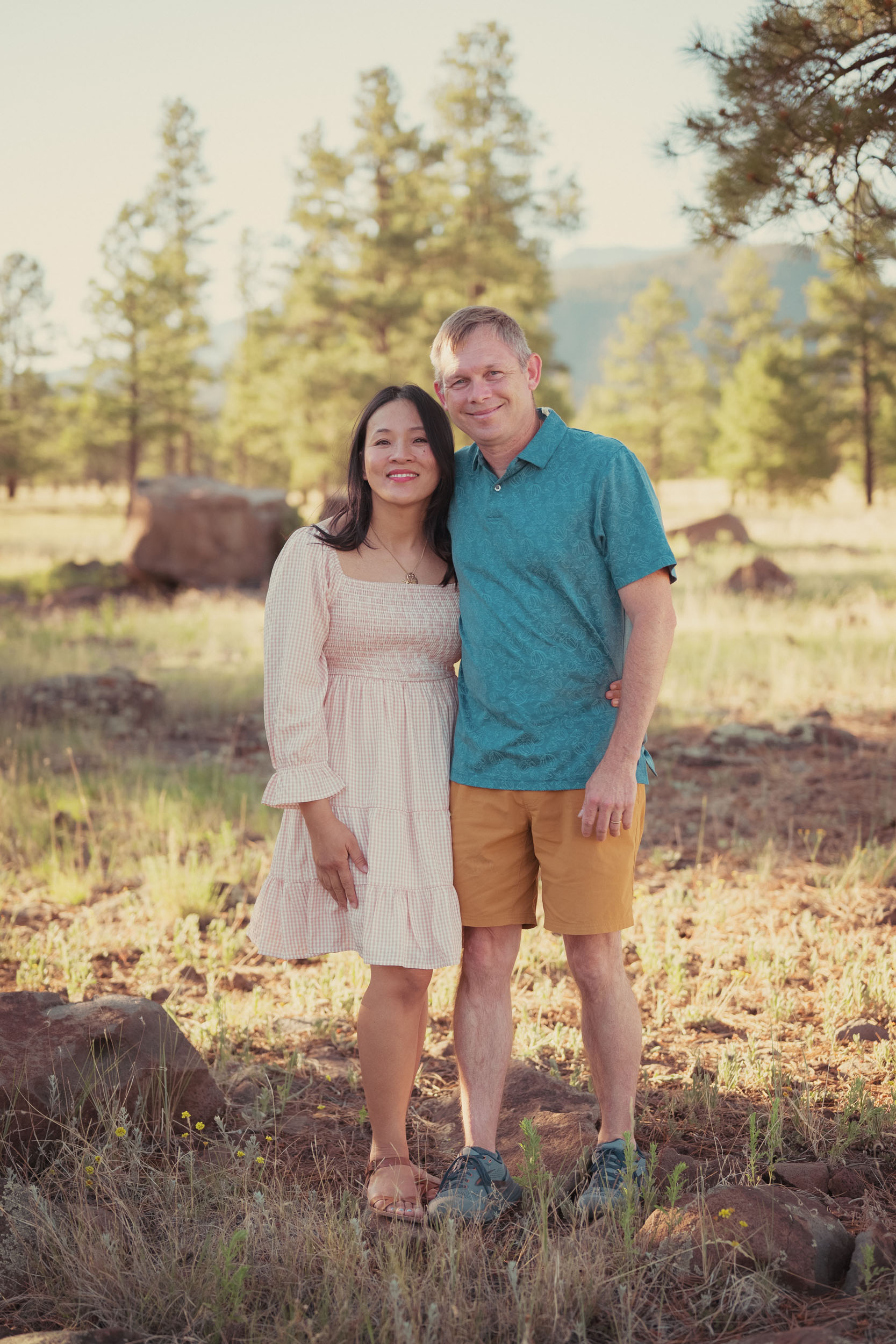 husband and wife standing in Flagstaff forest for portraits