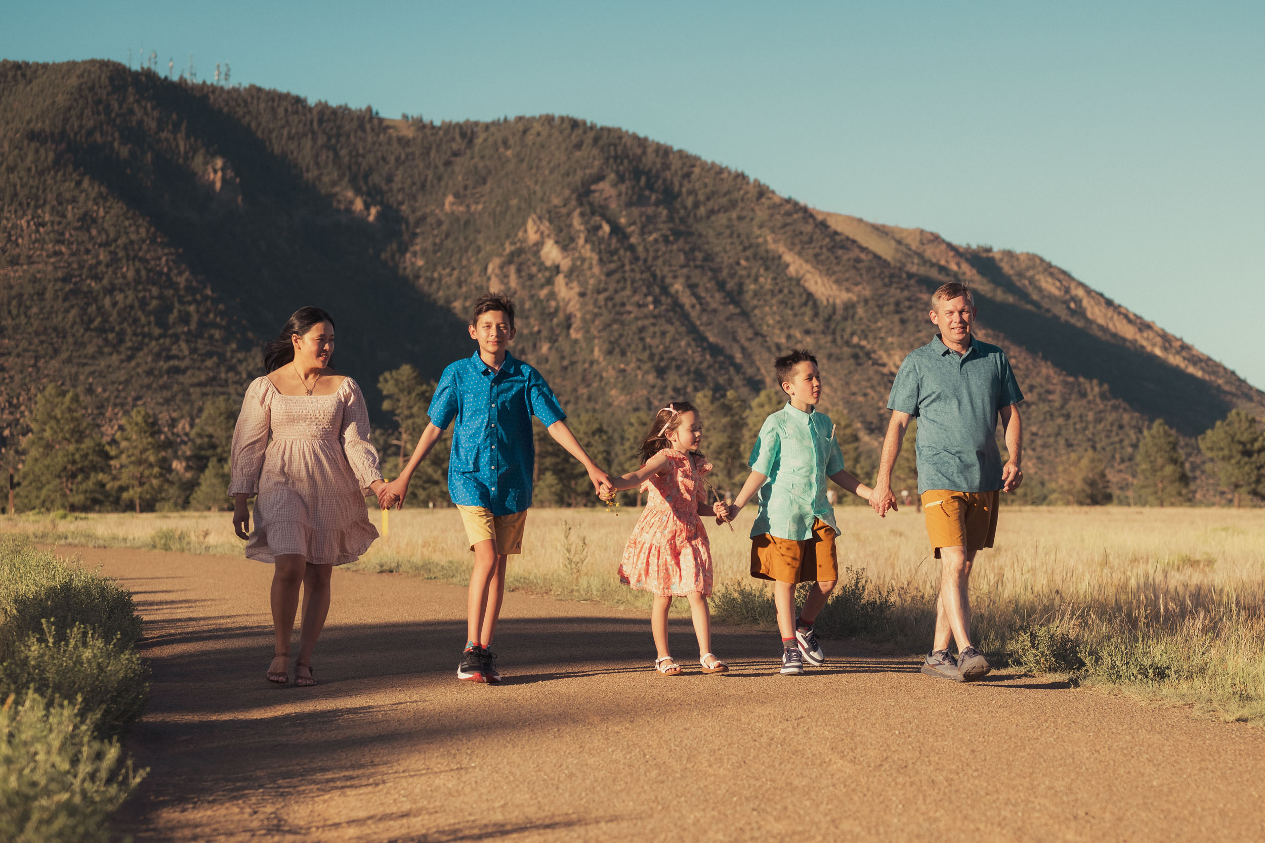 family holding hands walking the trail at Buffalo Park in Flagstaff Arizona