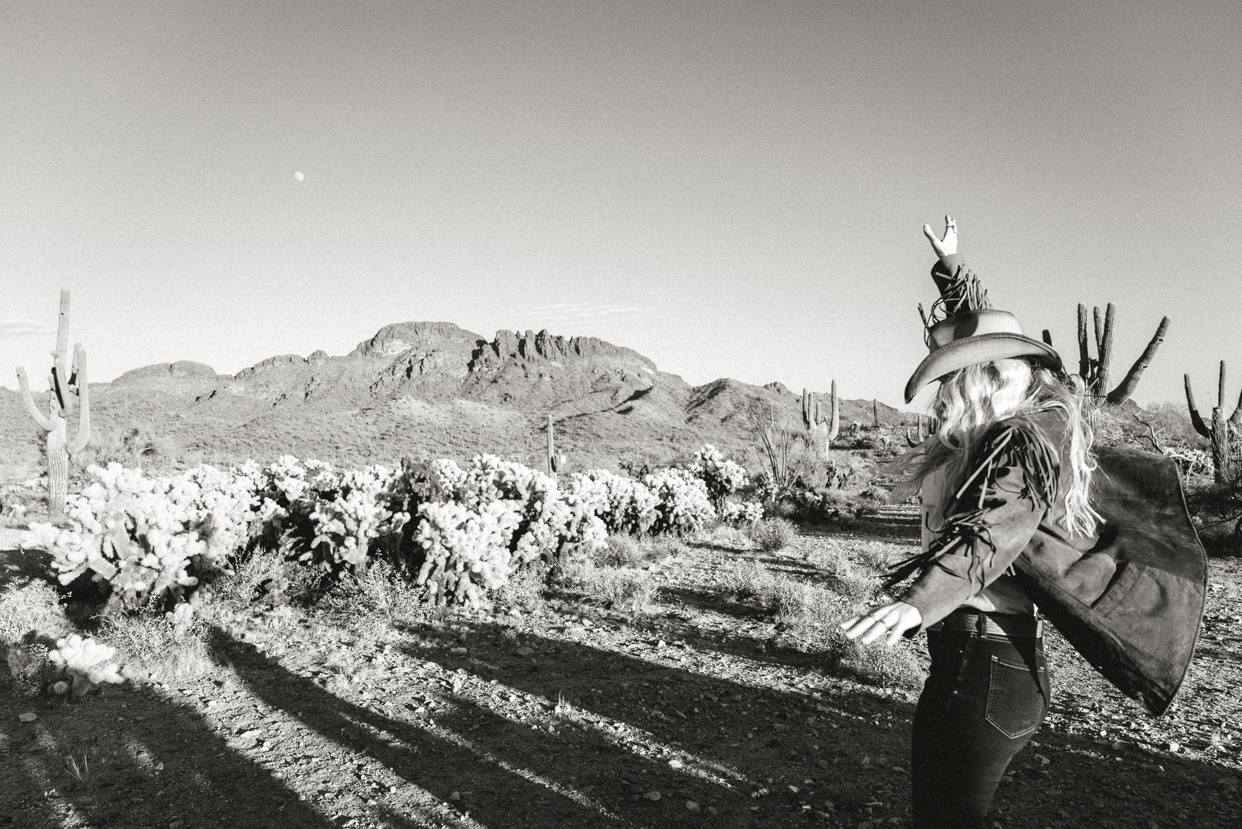 black an white photo of woman dancing in the desert at Vulture Peak in Wickenburg.