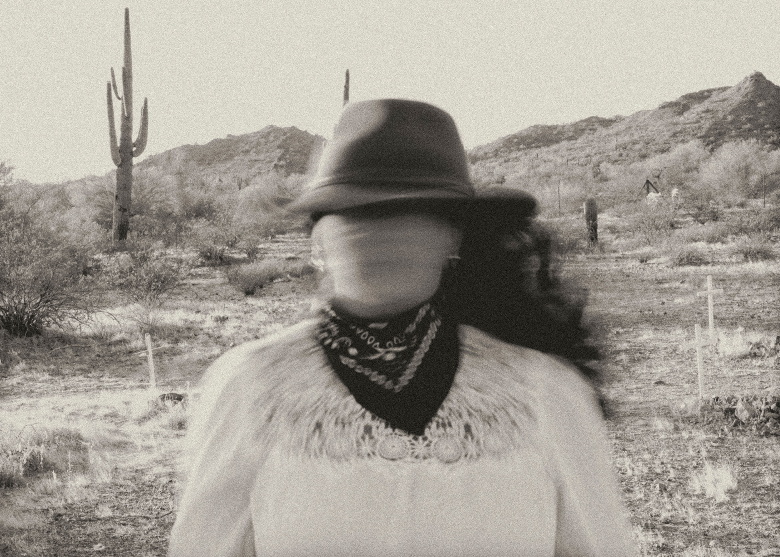 Woman in the desert with face blurred depicting Time's Blur a Lord Huron reference.